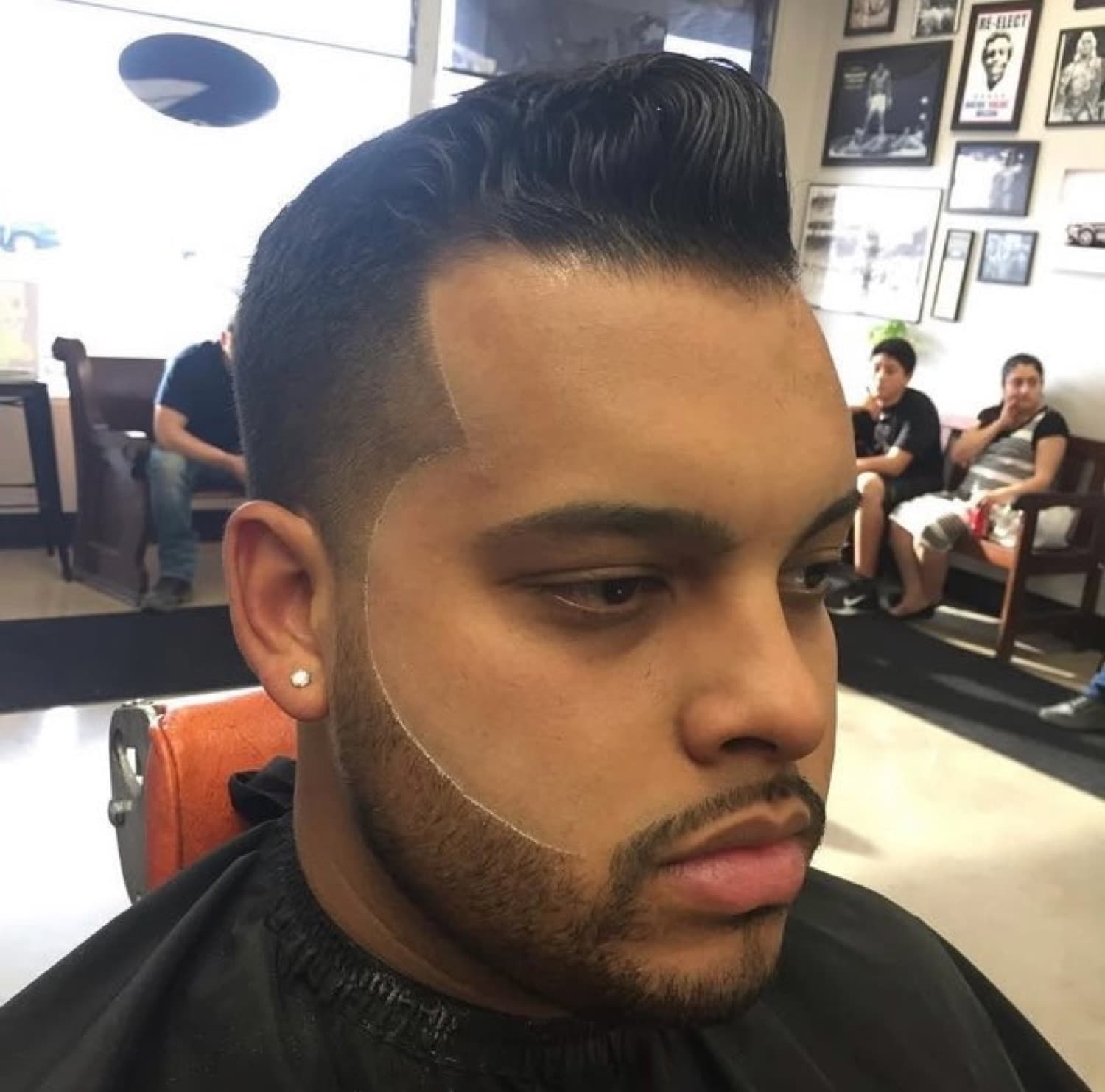 Tall pompadour quiff with a razor-sharp lineup and beard work.