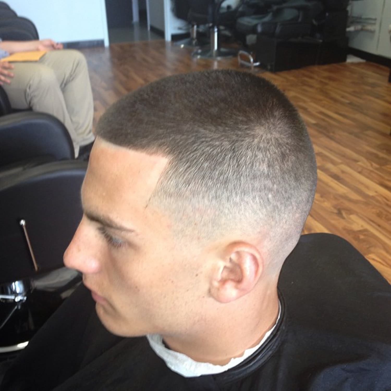 Clean buzz fade, side profile.