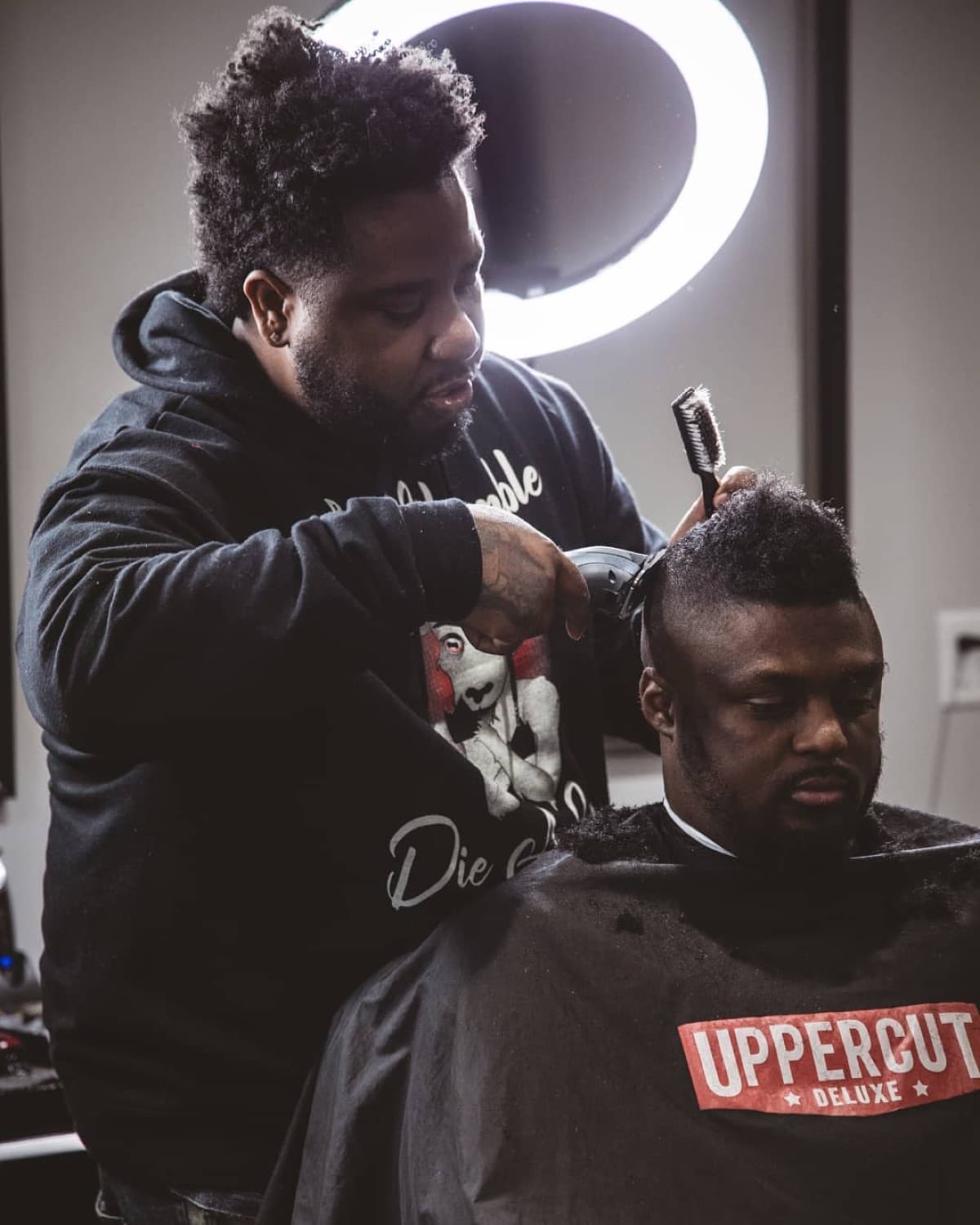 Brushing out a fresh cut under the ring light.
